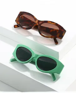 Detailed close-up of retro cat-eye sunglasses in tortoiseshell and mint green finishes