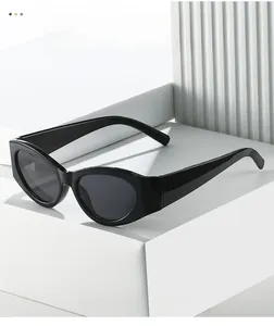 Detailed view of vintage cat-eye sunglasses in black resin finish on a minimalist display