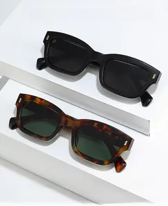 Detail of square sunglasses with tortoise texture and gold triple-stripe metal hinges