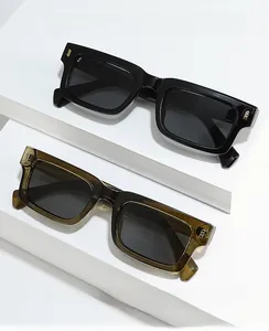 Detail of square vintage sunglasses with gold rivets on black and olive green frames