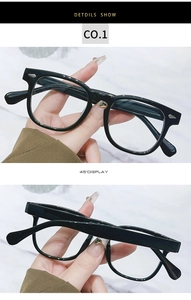 Detail showing polished black full-frame retro glasses with silver stud accents