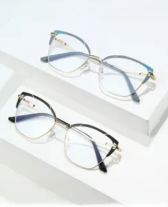 Close-up of cat-eye metal glasses frames in black and blue gold on display stands