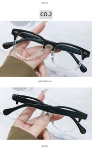 Detail of retro round glasses frame with golden heart hinges and marble background