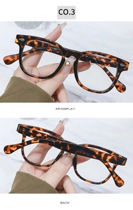 Detail view of tortoiseshell round frames with metallic accents on a marble background