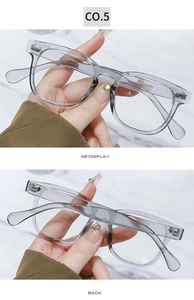 Detail view showing metal hinges and transparent grey frames of vintage round glasses