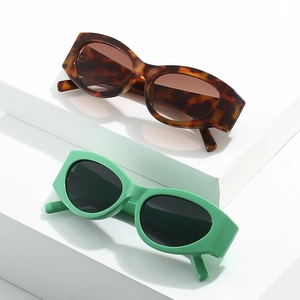 Retro cat-eye sunglasses set in tortoiseshell brown and mint green on white display
