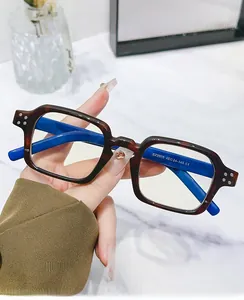 Detail view of square tortoiseshell eyeglasses with blue inner frame and model specs