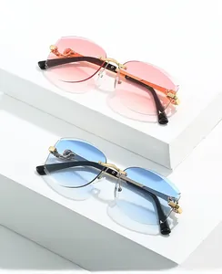 Détail du motif panthère en métal sur lunettes de soleil sans monture dégradé