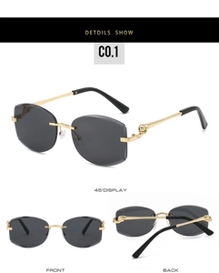 Détails de lunettes de soleil sans monture avec cadre en métal doré et crâne gravé