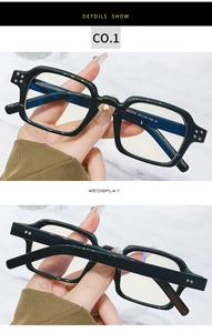 Macro view of square black frame glasses with metal rivets and SZ2005 model engraving