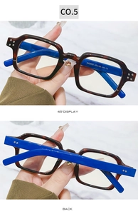 Detail view of square tortoiseshell frame with vibrant blue temples and silver rivets