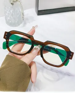 Close-up of tortoise shell square glasses frame with vibrant green translucent temples