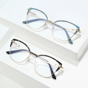 Cat eye cat-eye mixed metal frames in black gold and blue green on white pedestals