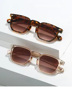 Close-up of stylish polygon frames with silver metal hinges and gradient brown lenses