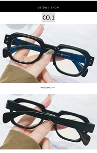 Macro detail of black rectangular anti-blue light glasses with size specs on the temple