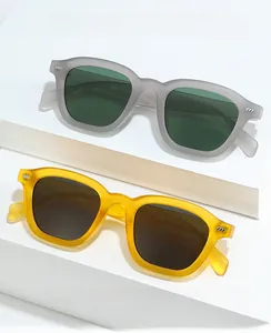 Retro square sunglasses with matte frames and dark lenses shown on a podium