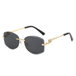 Lunettes de soleil sans monture avec détail tête de renard dorée et verres foncés