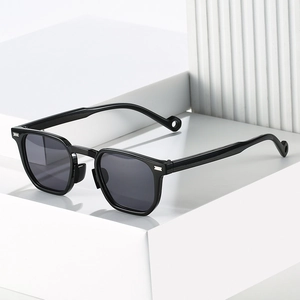 Modern black square frame sunglasses with silver accents on a minimalist white display