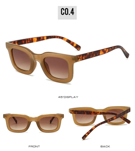 Detail view of square tortoiseshell sunglasses with brown gradient lenses and amber frames