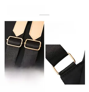 Detail showing adjustable gold-plated hardware and leather trim on the black backpack