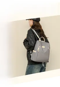 Detail of the gray waterproof Oxford backpack with adjustable beige straps and logo