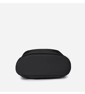 Macro view of the solid oval base and textured nylon fabric of the black travel backpack