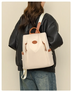 Waterproof oxford anti-theft backpack in beige with brown leather handles and side pocket
