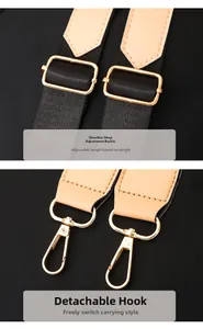 Detail of adjustable black woven strap with gold metal buckles and brown leather trim