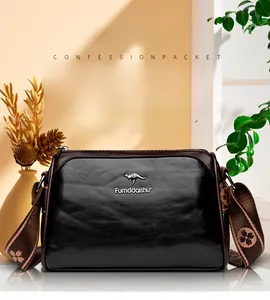 Detail of black oil wax leather pillow bag with floral strap and kangaroo logo
