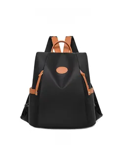 Front view of anti-theft oxford backpack with black nylon and brown leather accents