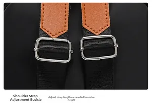 Detail of adjustable nylon strap with leather accents and silver metal buckle on black backpack
