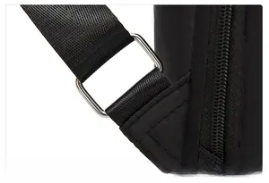 Reinforced triangular stitching on black nylon strap with metal buckle of anti-theft backpack