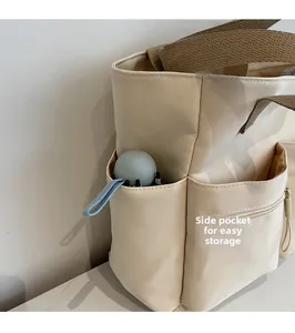 Detail of canvas tote bag side pocket holding a small umbrella for convenient storage