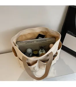 Detail view of nylon crossbody bag interior showing large capacity for laptop and daily items