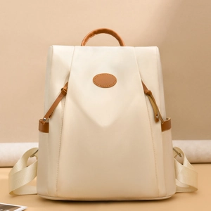 Waterproof cream nylon backpack for women with brown leather trim and anti-theft design