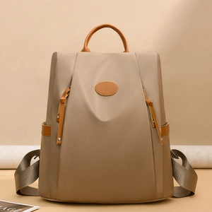 Waterproof khaki Oxford anti-theft backpack for women with brown leather accents and top handle