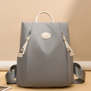Waterproof grey nylon anti-theft backpack for women with white trim and side pockets