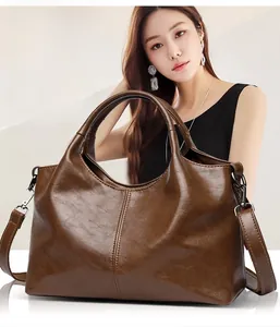 Detail of soft leather tote bag with contrast stitching and adjustable shoulder strap