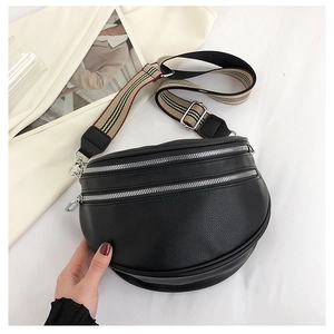 Detail of black pebbled leather crescent bag with double metal zippers and striped strap