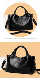 Detail of black soft PU leather handbag with cylindrical handle and gunmetal hardware