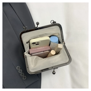 Internal view of shell handbag showing large capacity and herringbone fabric lining