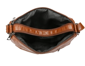 Macro detail of the three-compartment interior and soft PU leather on brown shoulder bag
