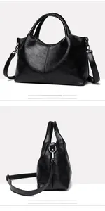 Detail view of large black soft leather tote showing fine stitching and adjustable strap