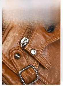 Detail of silver metal zipper pull and logo rivet on brown pebble leather handbag