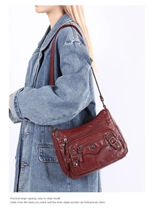 Detail view of large dark red PU leather shoulder bag with multiple functional zip pockets