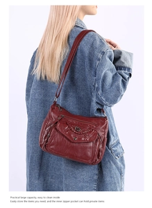 Detail view of the soft PU leather texture and multi-compartment design of the red crossbody bag