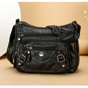 Detail view of black PU leather shoulder bag with multiple functional zipper pockets