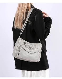 Detailed back view of a grey faux leather crossbody bag showing multiple pockets and straps
