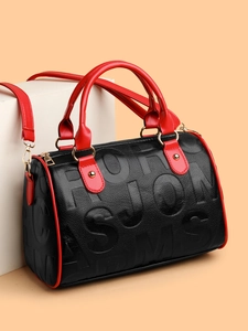 Detailed close-up of a Boston bag showing pebbled leather texture and embossed letters