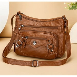 Detailed side view of brown PU leather shoulder bag with multiple zippered pockets